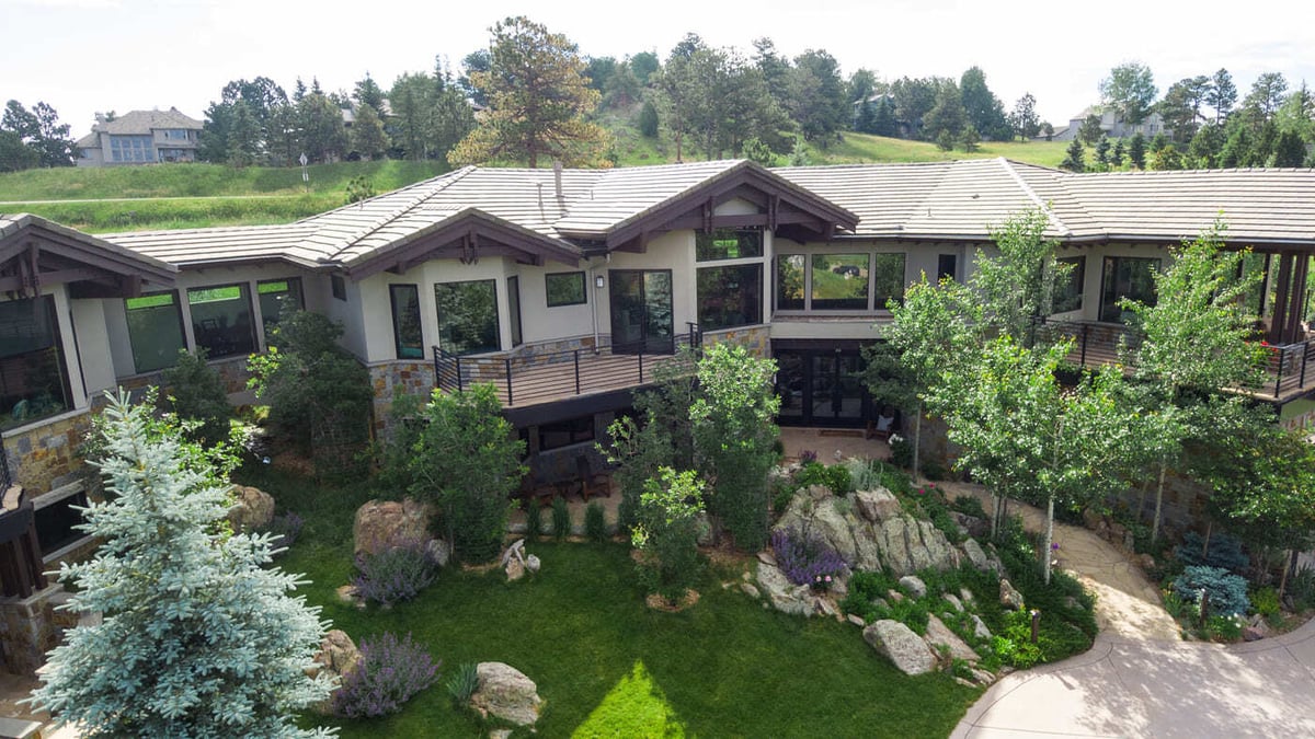 Genesee, CO renovation rear exterior with deck, stonework, and garden landscaping by Cillessen Construction