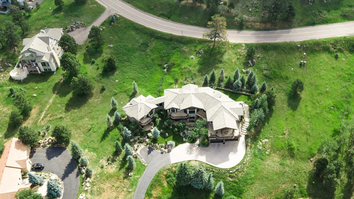 Genesee, CO renovation wide aerial with curved driveway and landscaped property by Cillessen Construction
