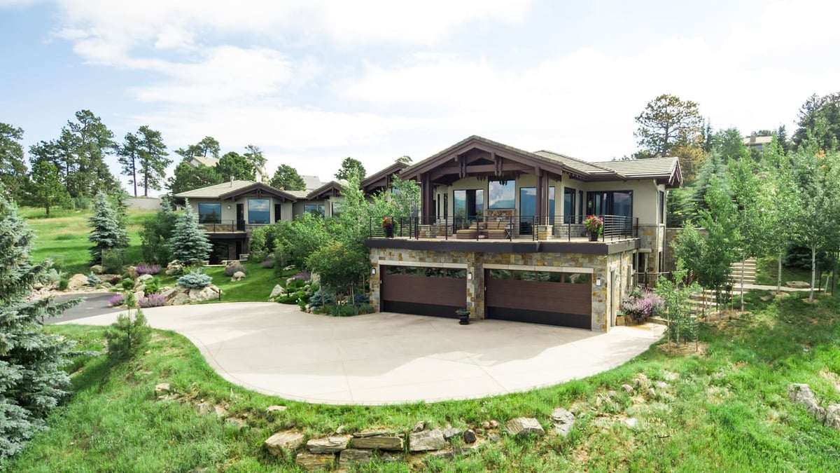 Genesee, CO renovation wide view of home, driveway, and surrounding greenery by Cillessen Construction
