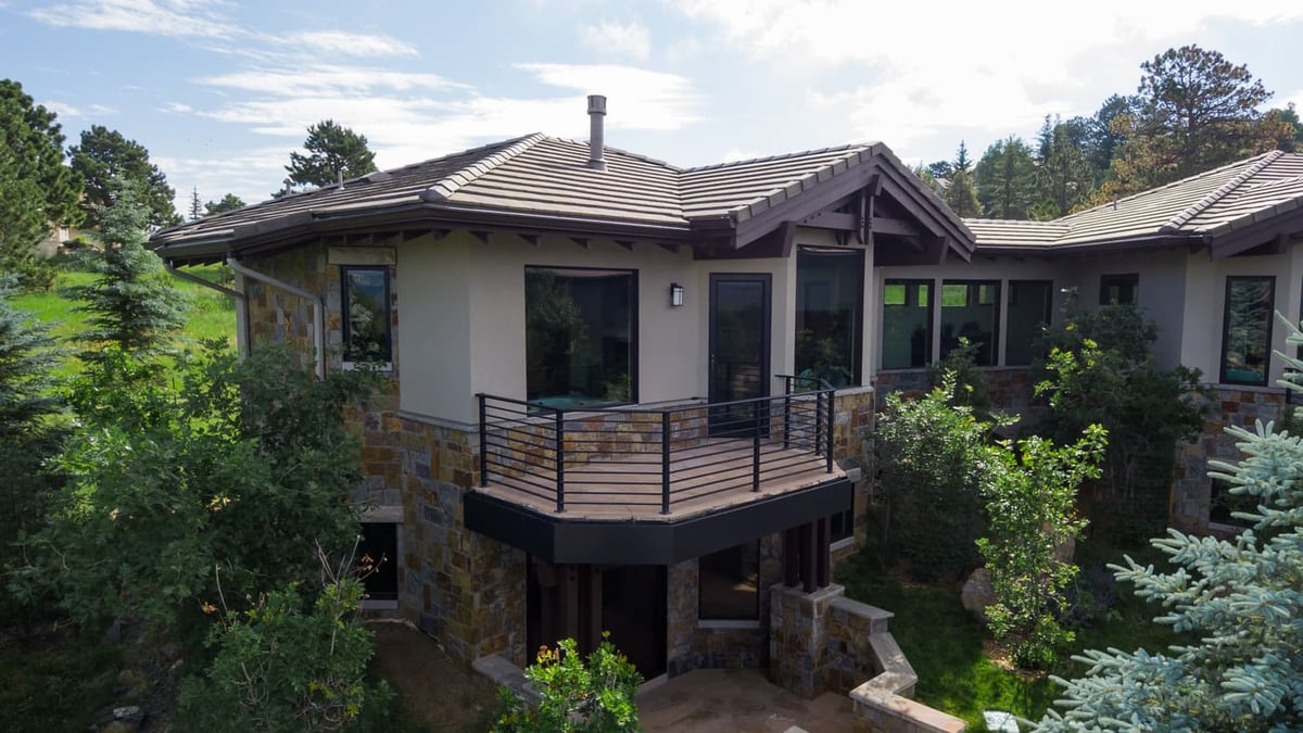 Genesee, CO renovation with elevated deck, stone exterior, and landscaping by Cillessen Construction