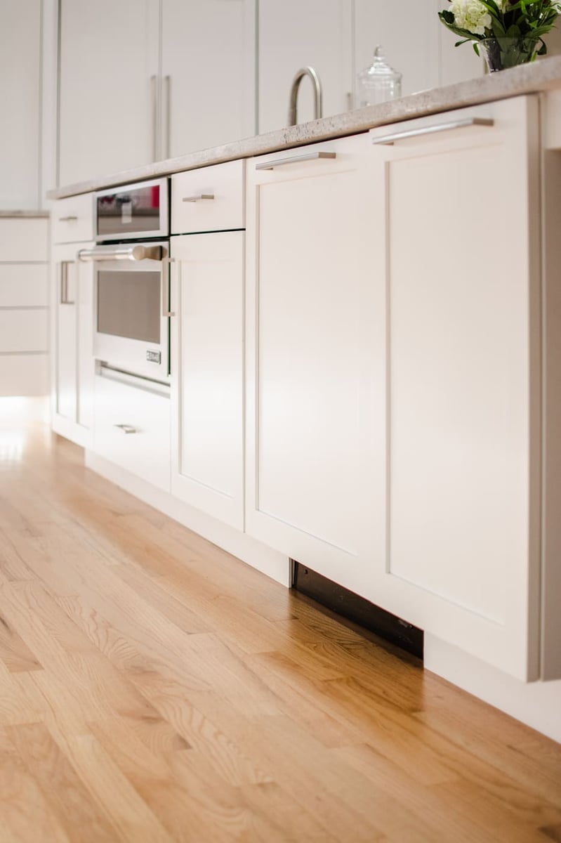 Applewood, CO kitchen renovation with white cabinetry, built-in oven, and hardwood floors by Cillessen Construction
