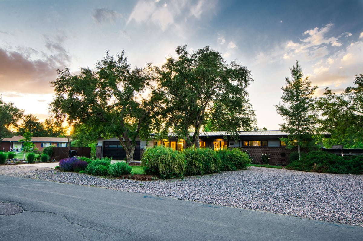 Applewood, CO renovation exterior at sunset with mature trees and updated mid-century home by Cillessen Construction
