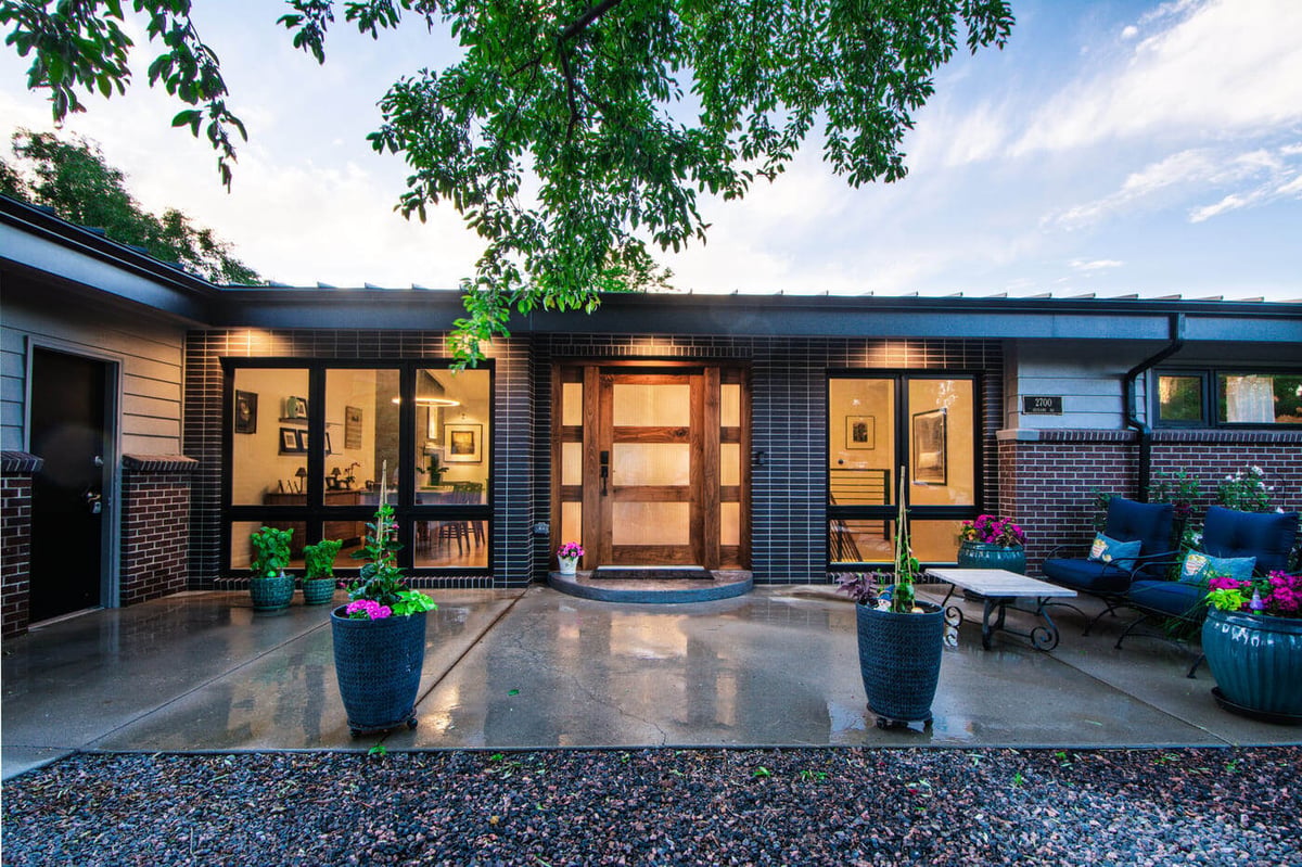 Applewood, CO renovation front patio with planters, seating, and modern entry by Cillessen Construction