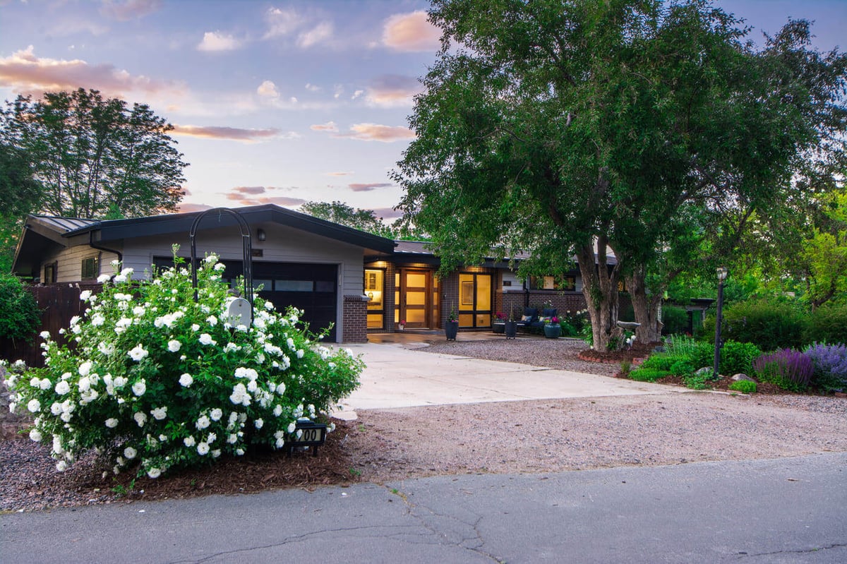Applewood, CO renovation front yard with driveway, landscaping, and modern home exterior by Cillessen Construction
