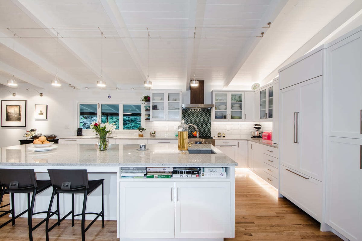 Applewood, CO renovation kitchen island with seating, quartz counters, and modern appliances by Cillessen Construction