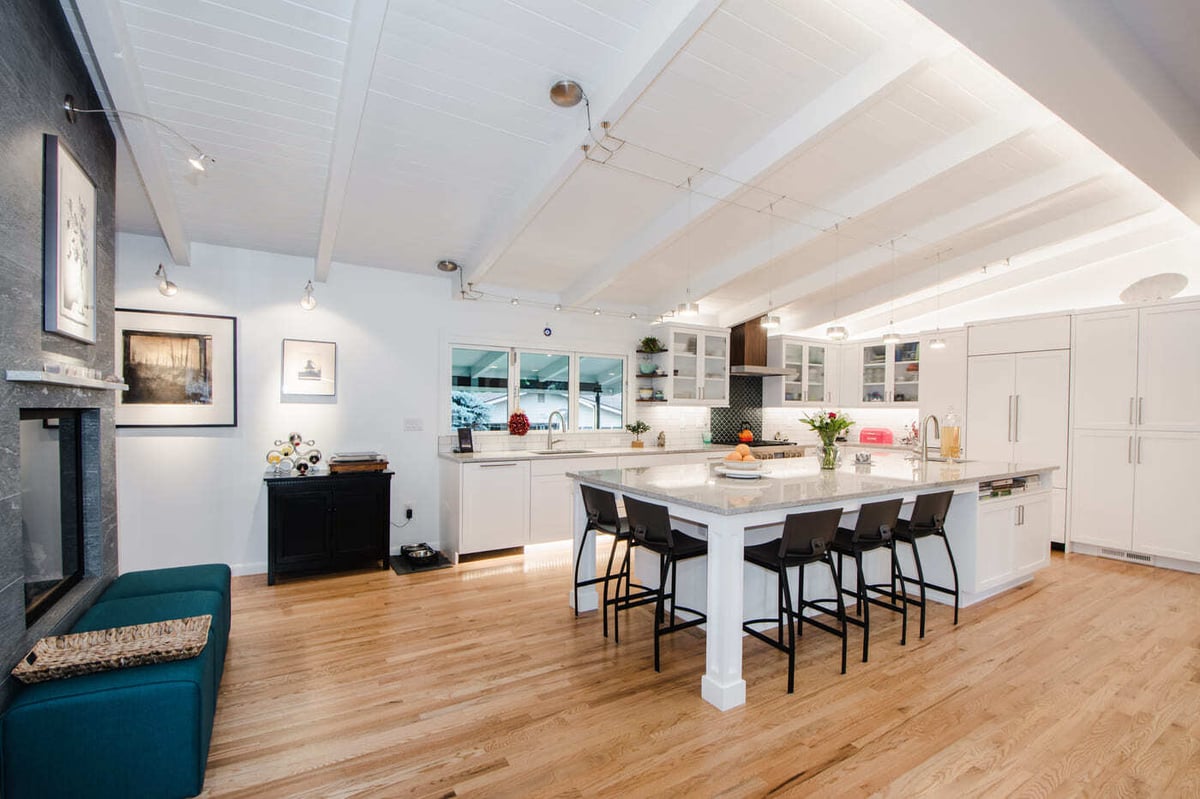 Applewood, CO renovation open kitchen and living area with fireplace and large island by Cillessen Construction
