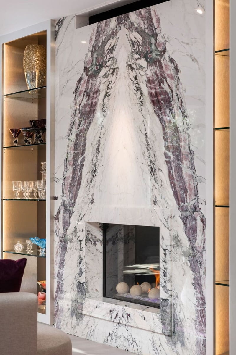 Greenwood Village, CO bookmatched marble fireplace with glass surround and display shelving, by Cillessen Construction
