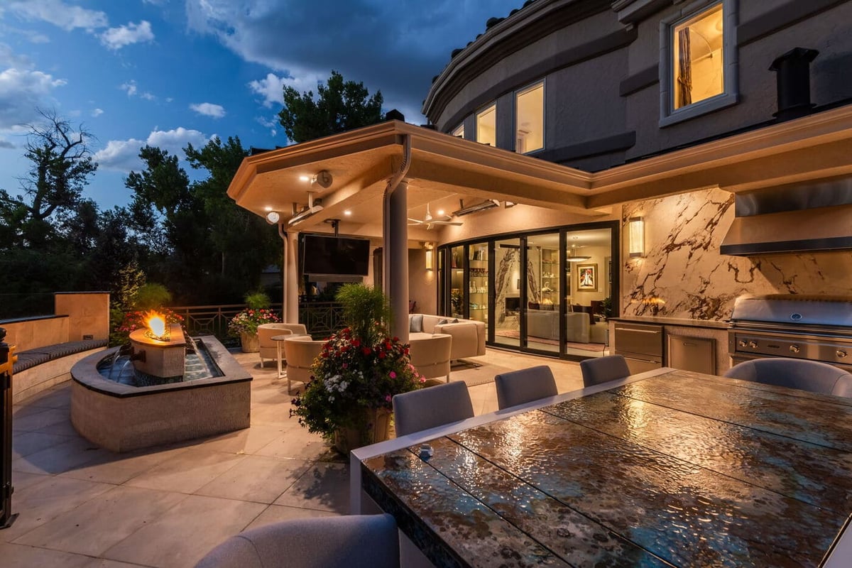 Greenwood Village, CO covered patio with fire and water feature and dining area, by Cillessen Construction