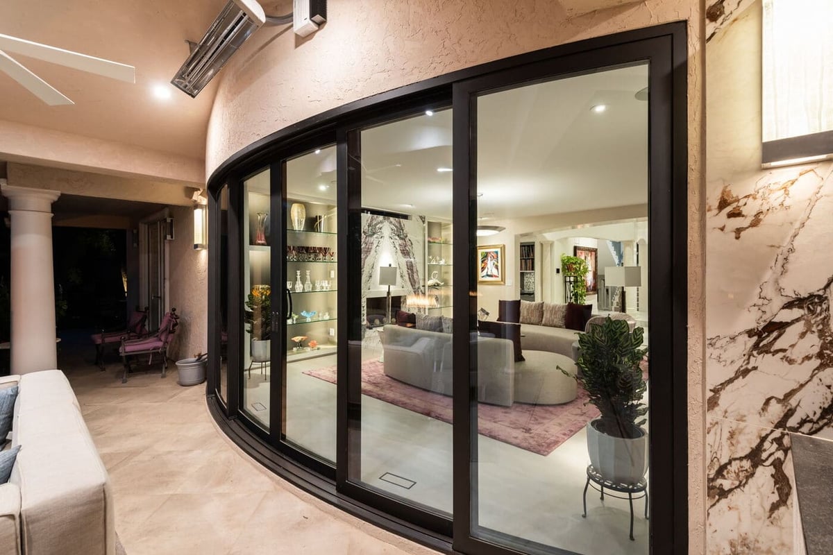 Greenwood Village, CO curved glass doors connecting patio to interior living space, by Cillessen Construction