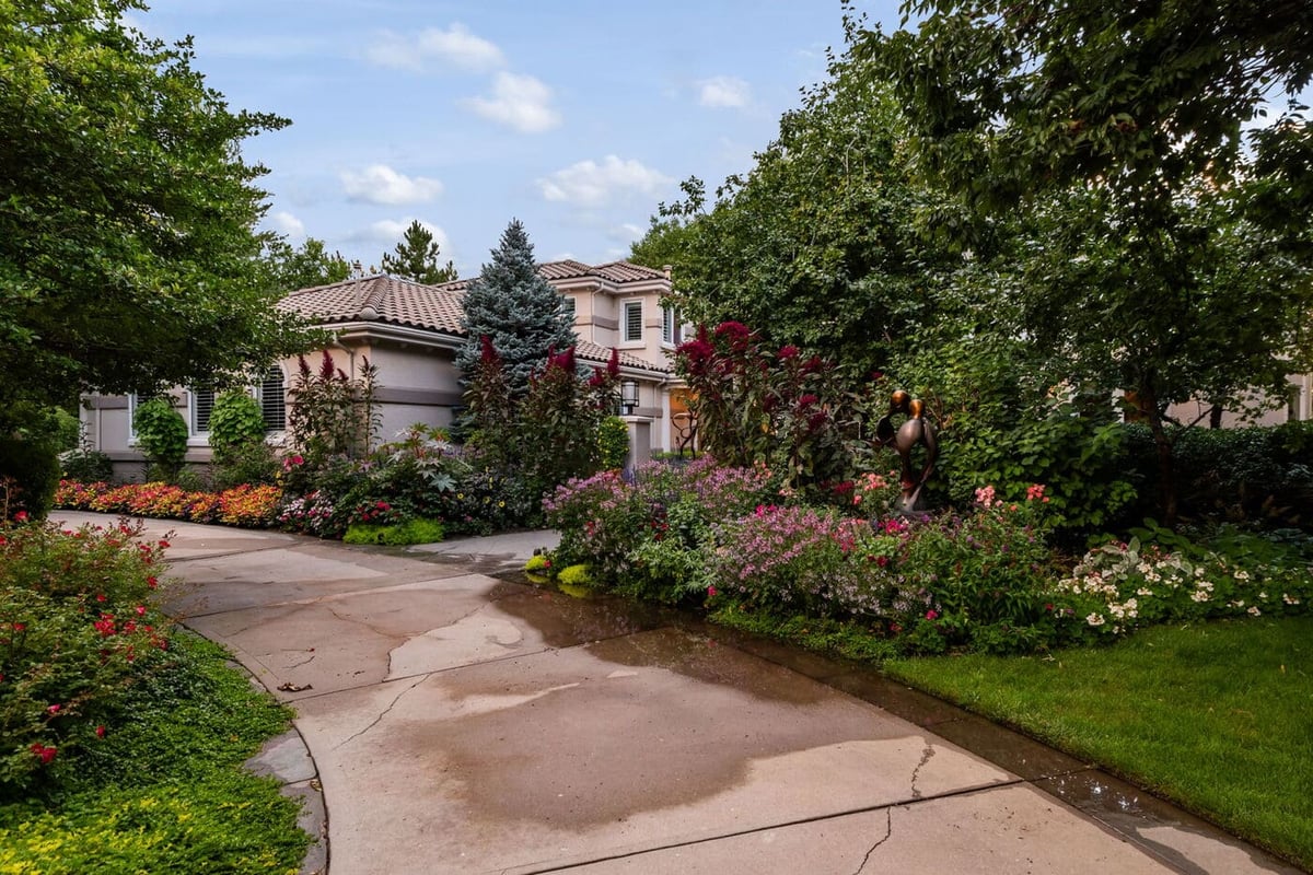Greenwood Village, CO exterior with landscaped driveway, greenery, and home facade by Cillessen Construction renovation