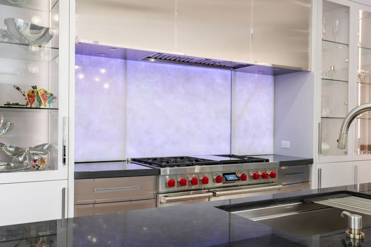 Greenwood Village, CO kitchen featuring luxury range, backlit backsplash, and sleek finishes by Cillessen Construction
