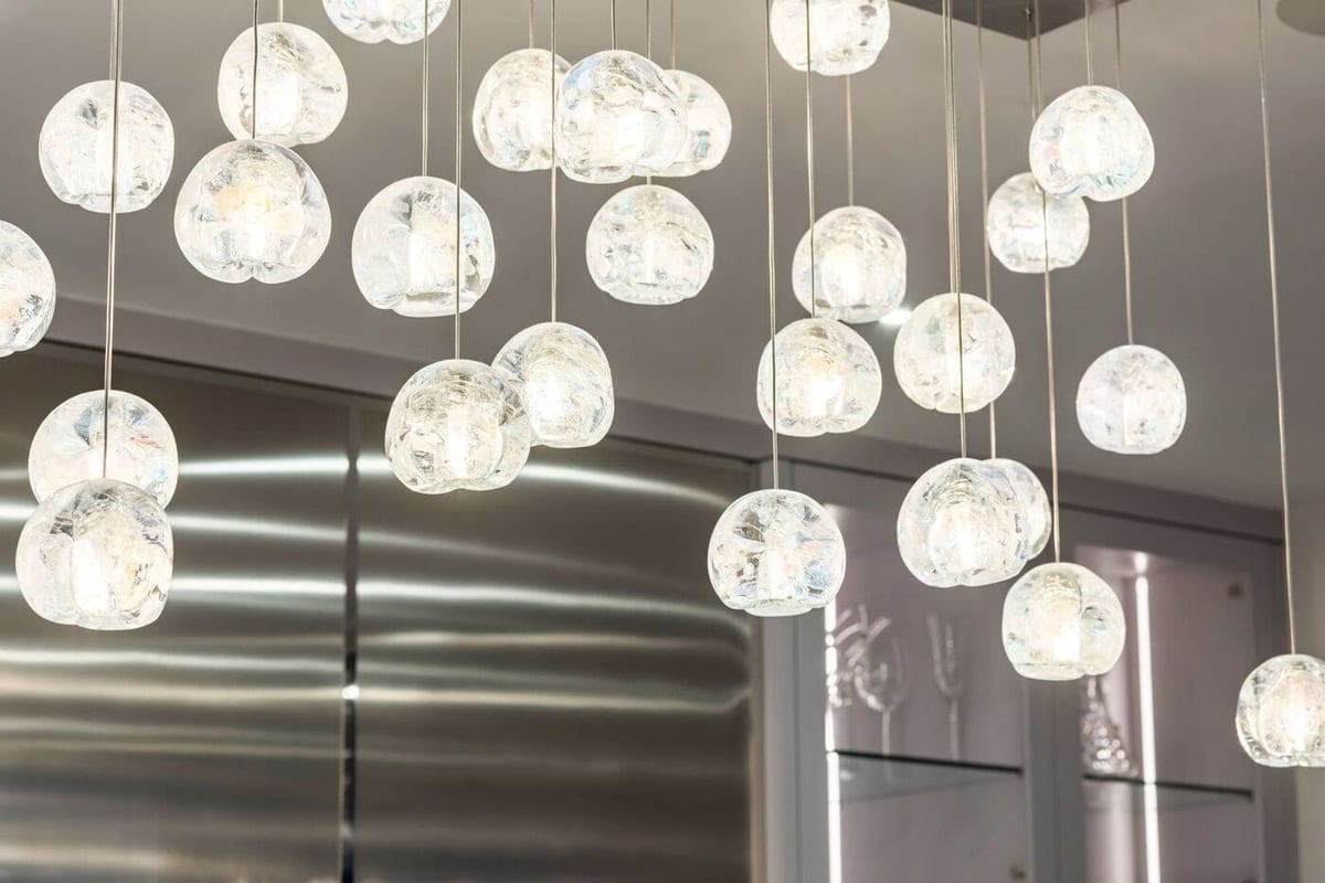 Greenwood Village, CO kitchen featuring modern glass globe pendant lighting by Cillessen Construction