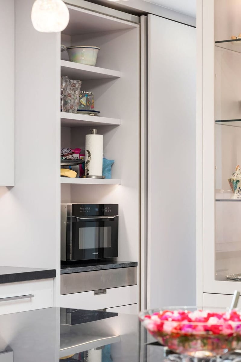 Greenwood Village, CO kitchen with built-in microwave, open shelving, and modern cabinetry by Cillessen Construction
