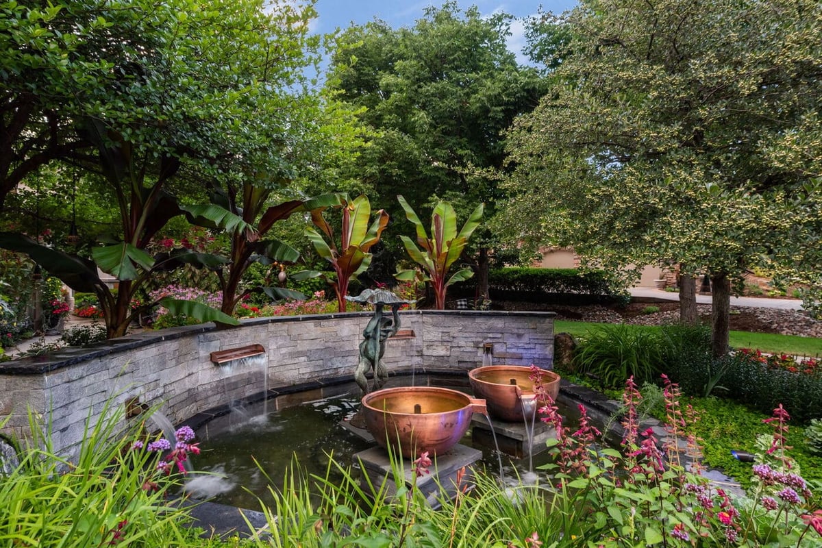 Greenwood Village, CO landscaped garden with fountain and lush greenery, renovation by Cillessen Construction