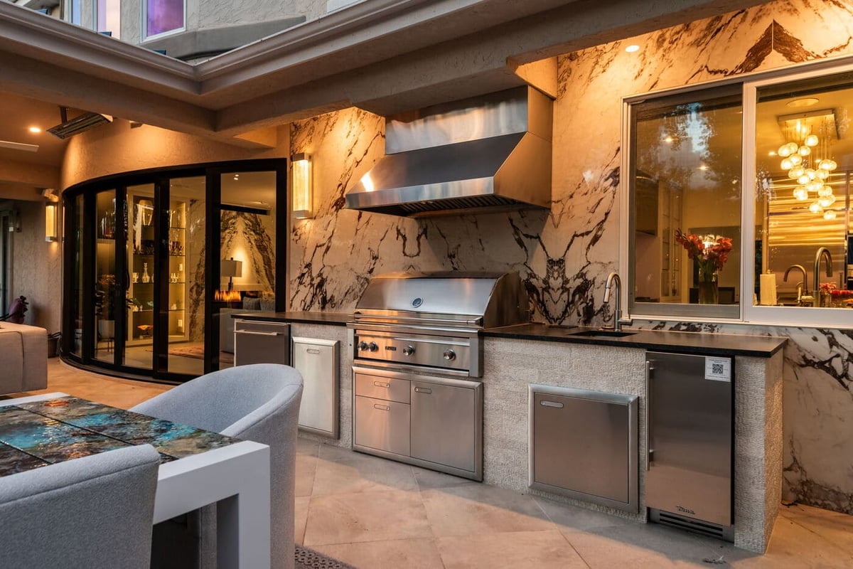 Greenwood Village, CO outdoor kitchen with marble backsplash and grill, renovation by Cillessen Construction