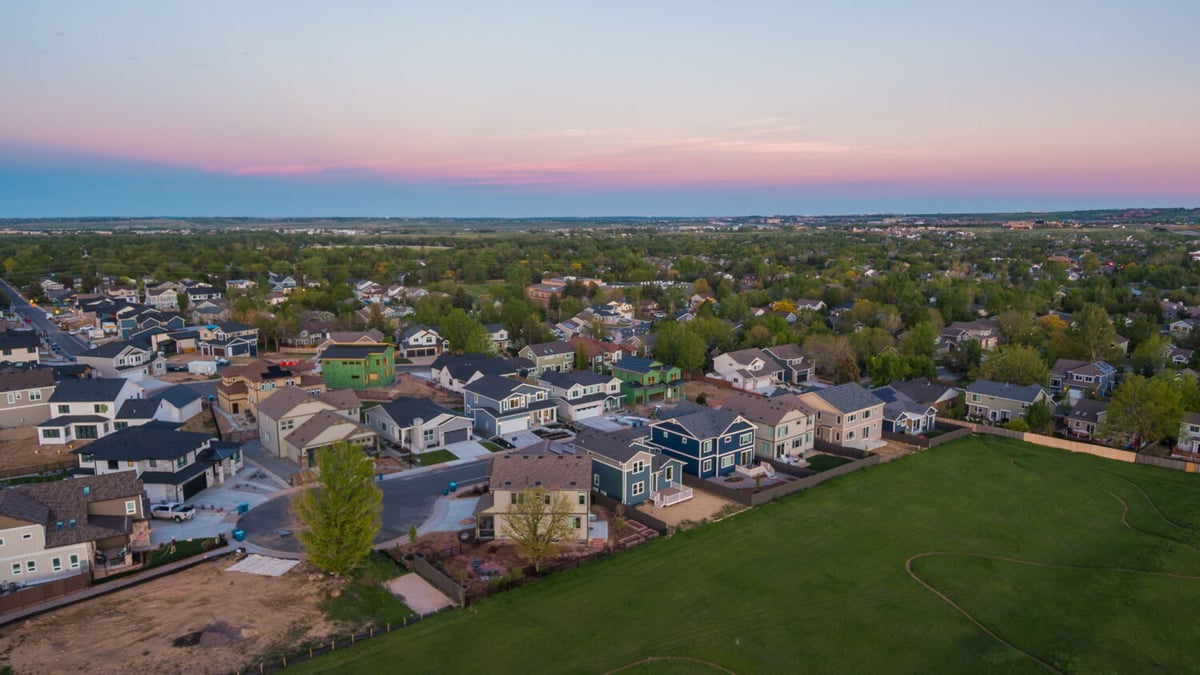 Aerial view of neighborhood at sunset surrounding custom home in Louisville, CO by Cillessen Construction