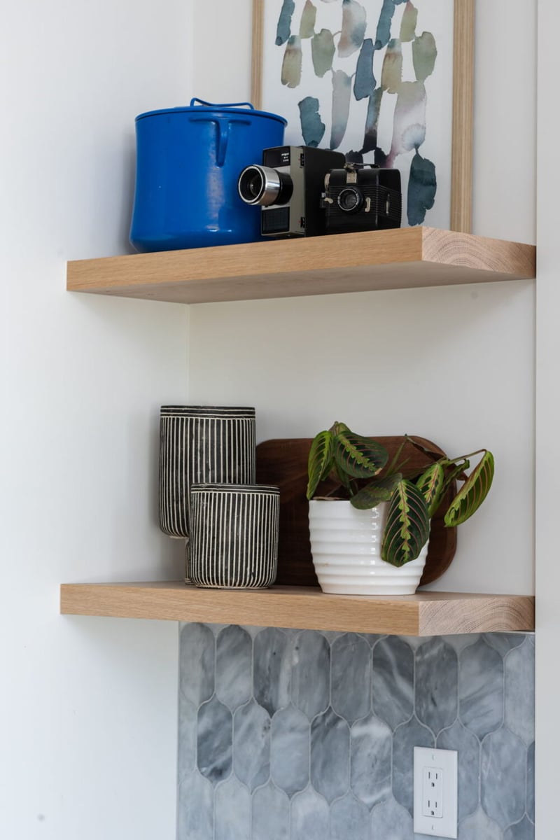 Close-up of open wood shelving with decor and plant in custom home in Louisville, CO by Cillessen Construction