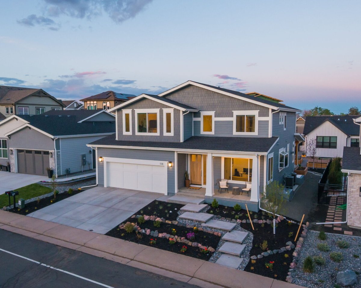 Front exterior at dusk with lit windows of custom home in Louisville, CO by Cillessen Construction