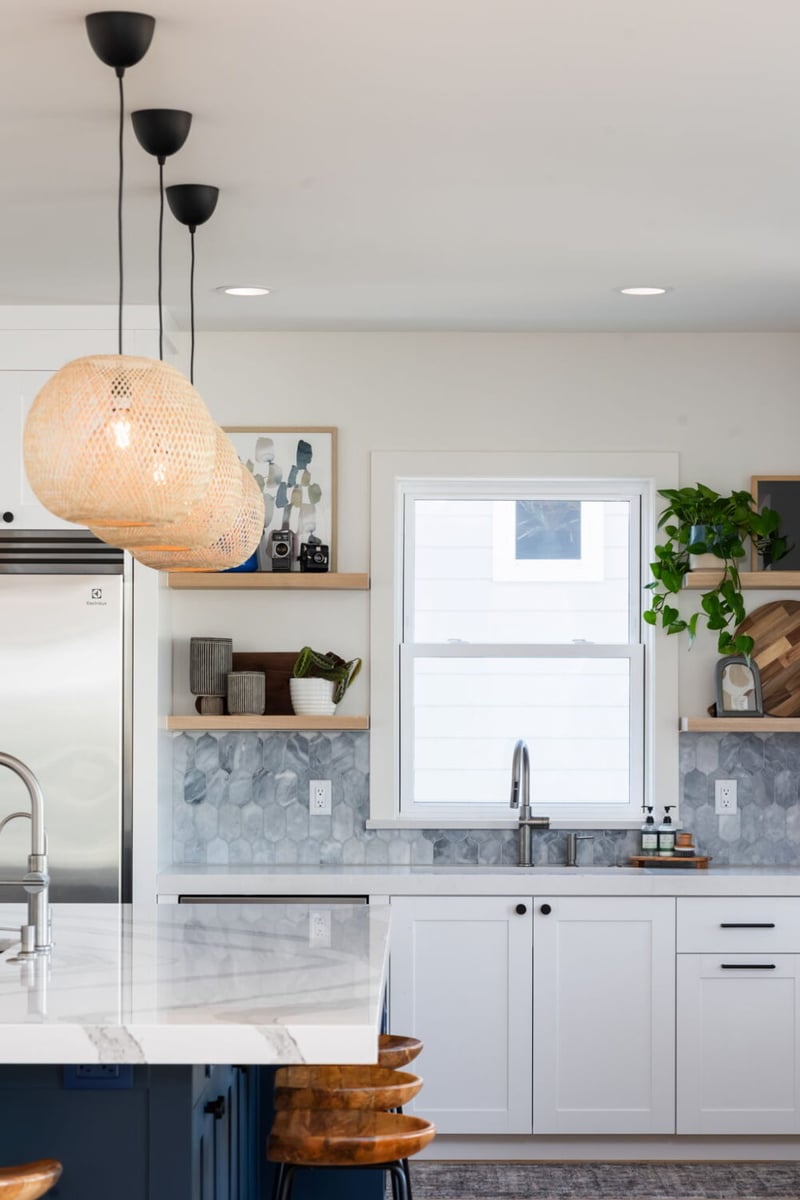 Kitchen detail with woven pendant lights, open shelves, and window in custom home in Louisville, CO by Cillessen Construction