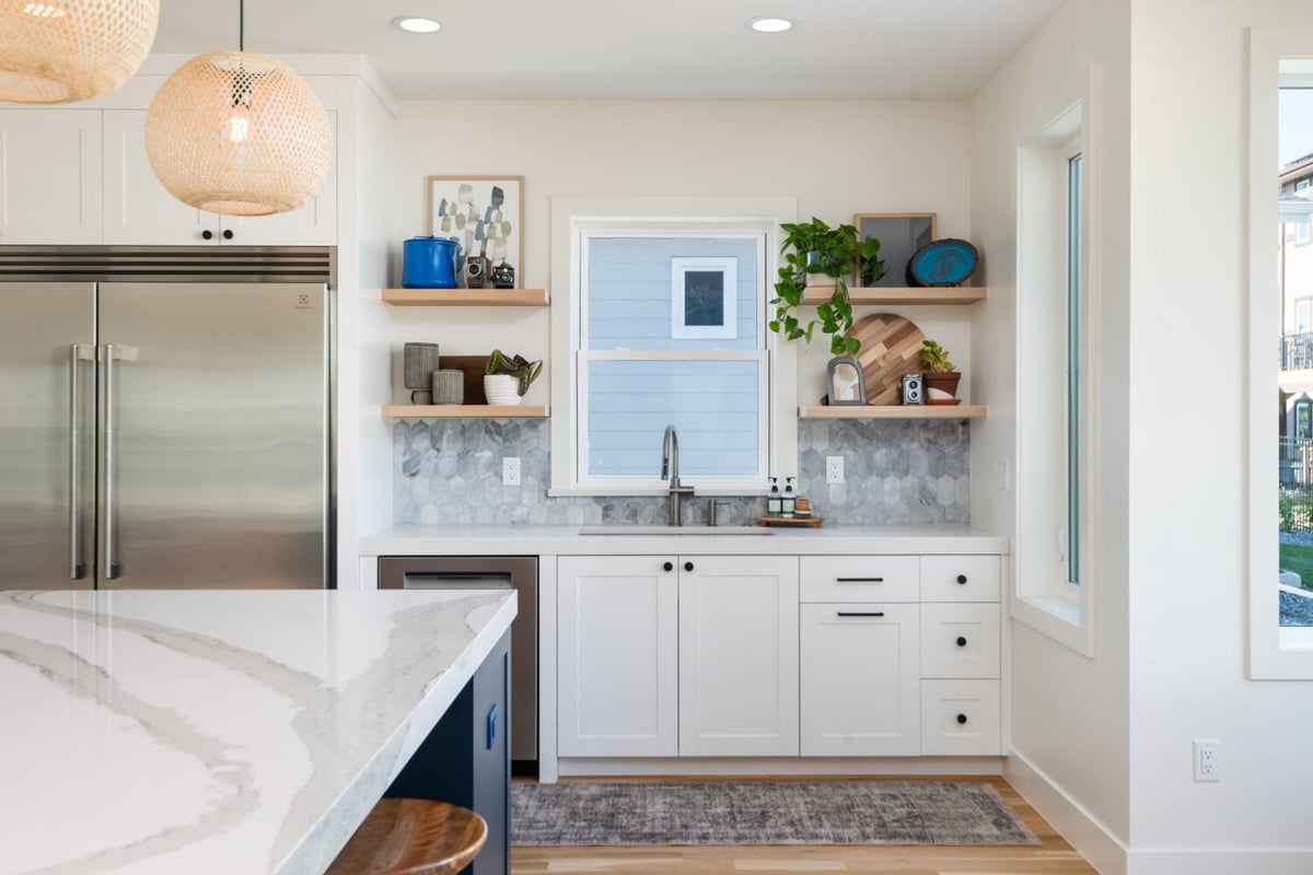 Kitchen sink wall with floating shelves and tile backsplash in custom home in Louisville, CO by Cillessen Construction