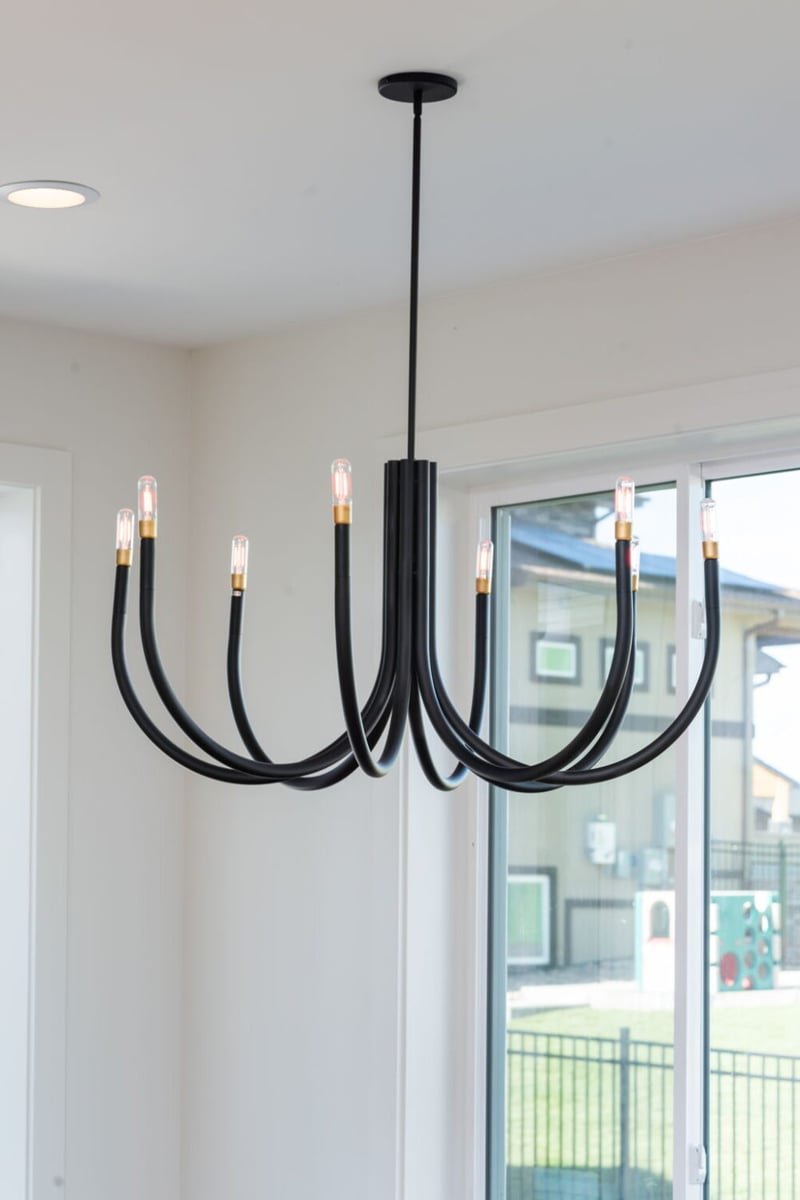 Modern black chandelier with exposed bulbs in custom home in Louisville, CO by Cillessen Construction