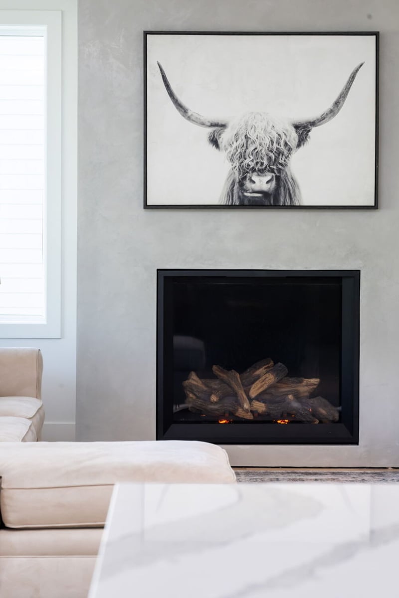 Modern fireplace with framed art above in custom home in Louisville, CO by Cillessen Construction