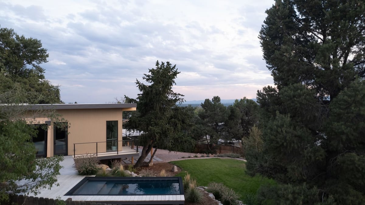 Backyard view with modern addition and pool in Arvada, CO pop top renovation by Cillessen Construction