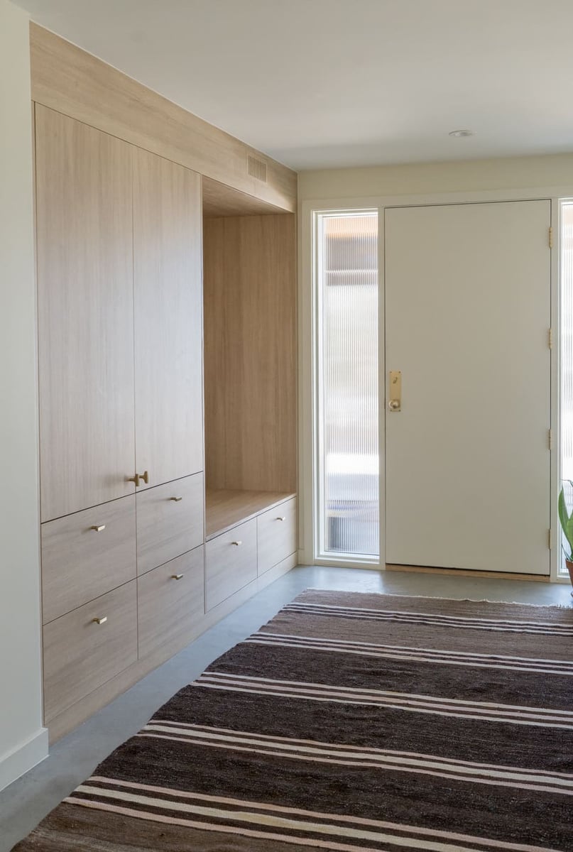 Built-in entry storage and bench in pop top renovation in Arvada, CO by Cillessen Construction