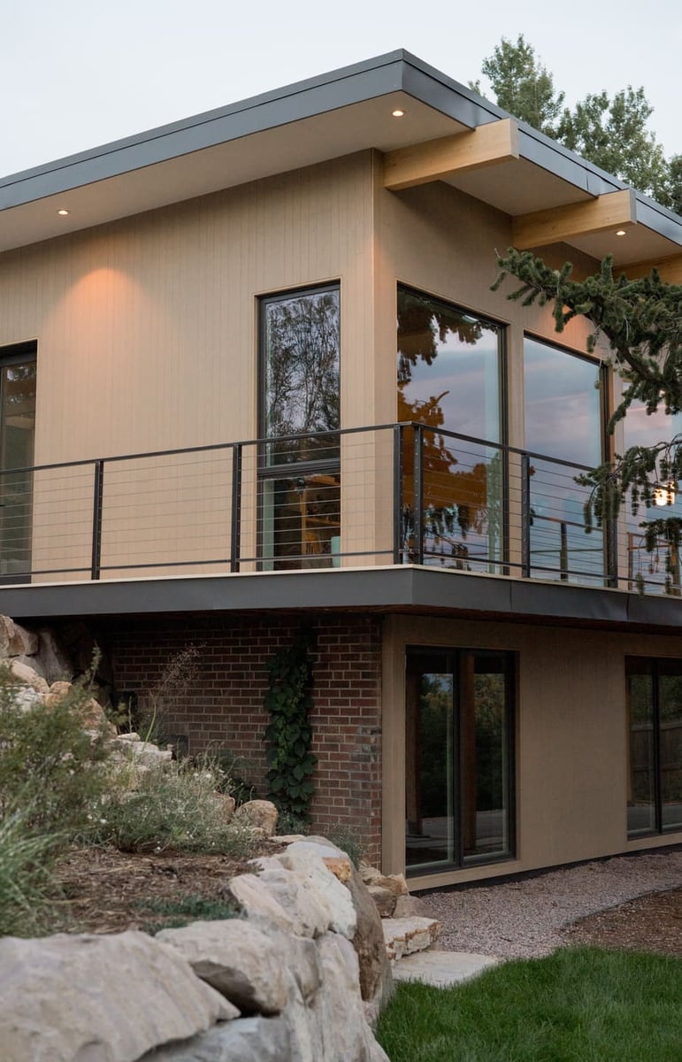 Corner detail of modern pop top renovation with large windows and railing in Arvada, CO by Cillessen Construction