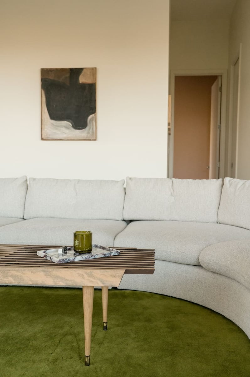 Curved white sofa and wood coffee table in Arvada, CO pop top renovation by Cillessen Construction