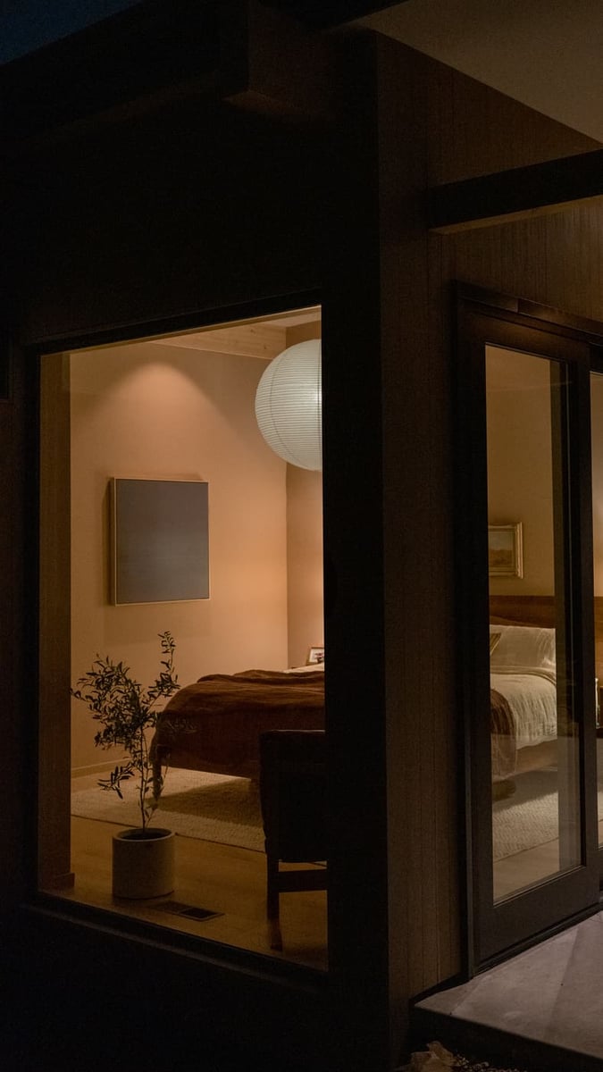 Exterior corner view showing cozy bedroom interior at night in Arvada, CO pop top renovation by Cillessen Construction