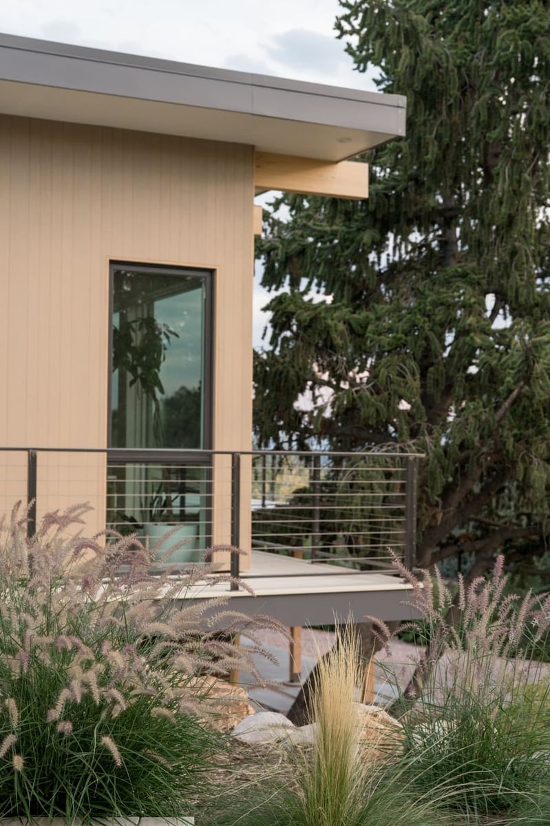 Exterior detail with deck, railing, and landscaping in Arvada, CO pop top renovation by Cillessen Construction