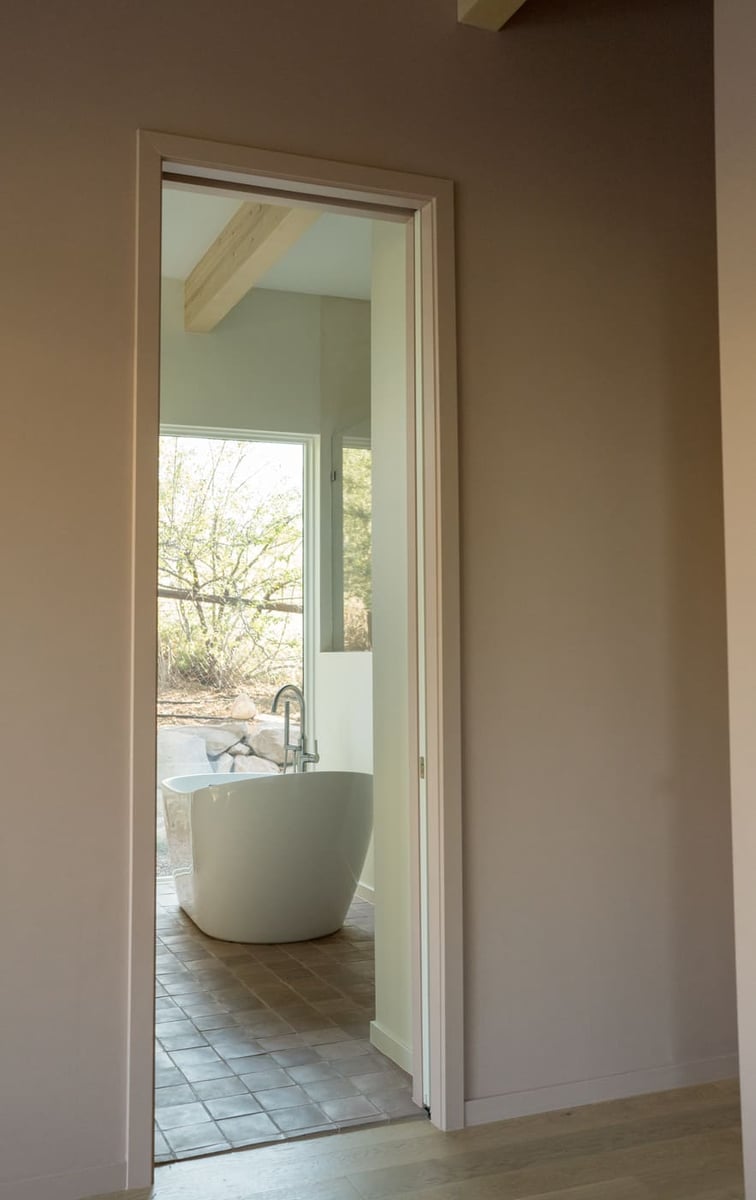 Freestanding tub viewed through doorway in Arvada, CO pop top renovation by Cillessen Construction