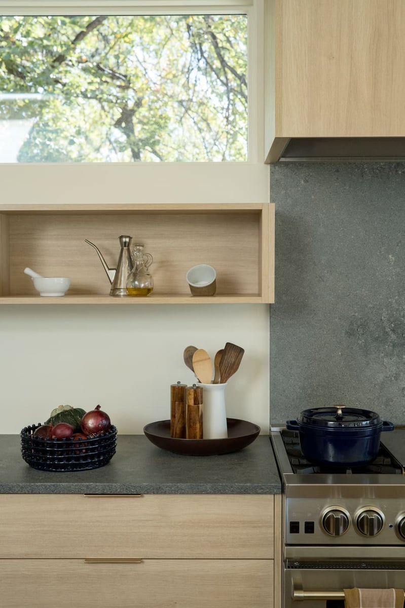 Kitchen detail with open shelving, stone backsplash, and decor in Arvada, CO pop top renovation by Cillessen Construction