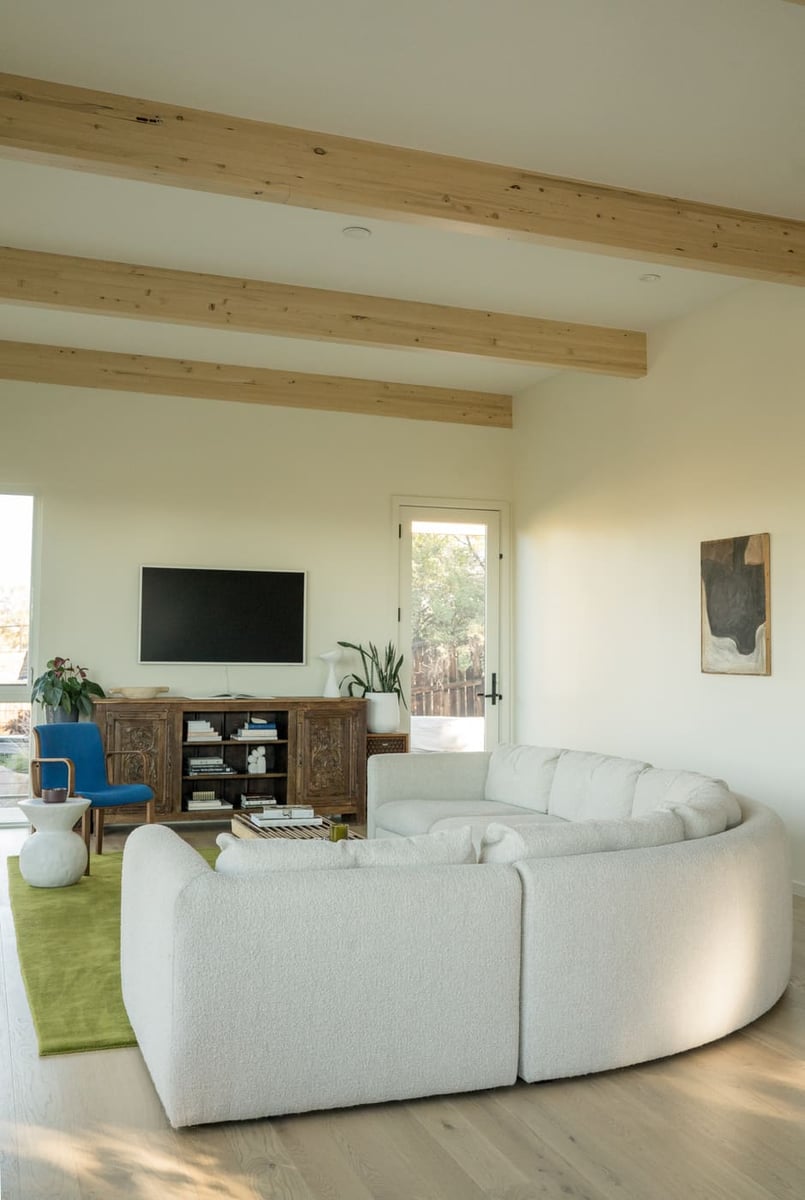 Living room with wood console and TV in Arvada, CO pop top renovation by Cillessen Construction