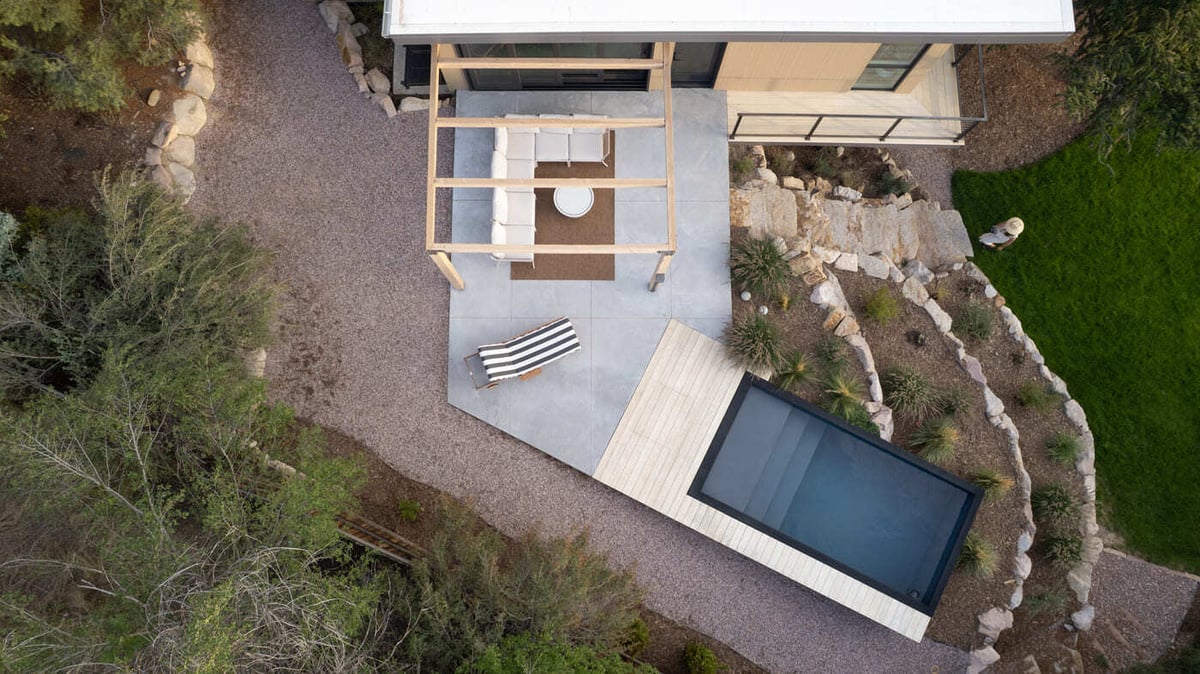 Modern pop top renovation with deck, pergola, and plunge pool in Arvada, CO by Cillessen Construction