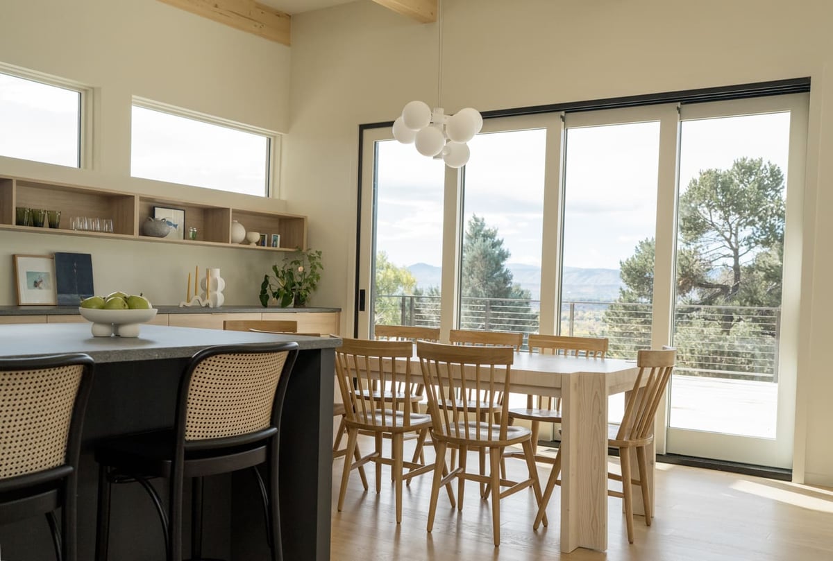 Open dining and kitchen with large windows and mountain views in Arvada, CO pop top renovation by Cillessen Construction