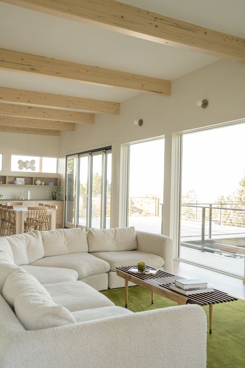 Open living room with curved sofa in Arvada, CO pop top renovation by Cillessen Construction