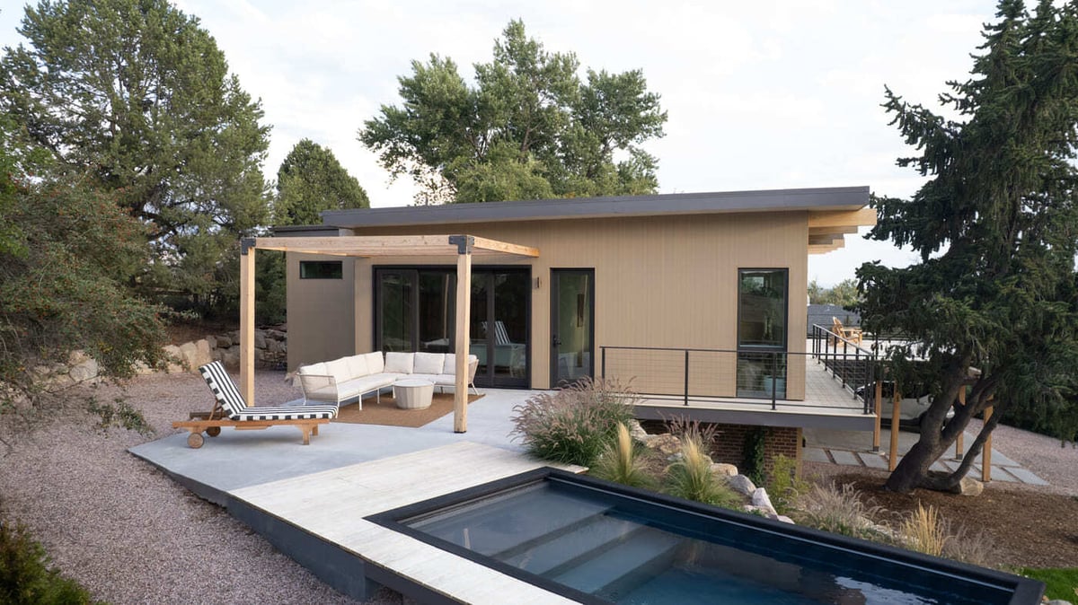 Pop top renovation exterior with deck, pergola, and plunge pool in Arvada, CO by Cillessen Construction