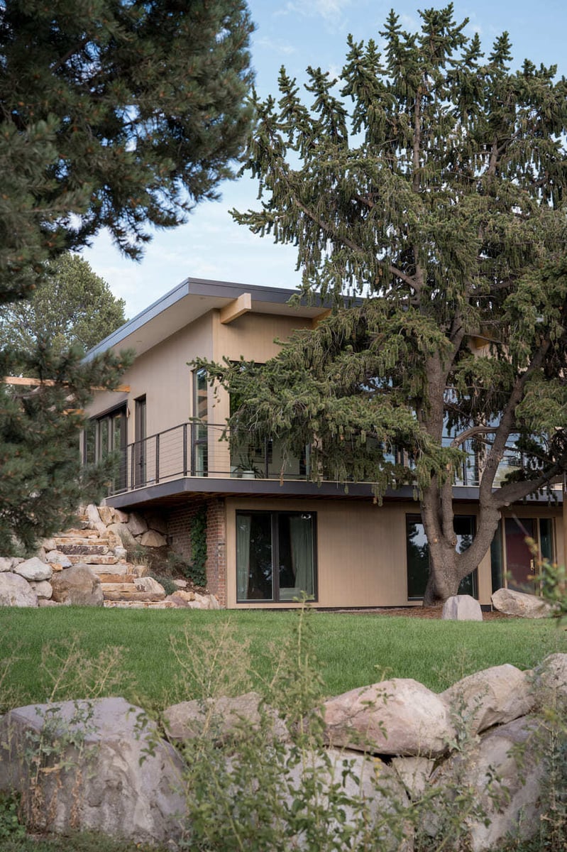 Rear view of pop top renovation with elevated deck and large windows in Arvada, CO by Cillessen Construction