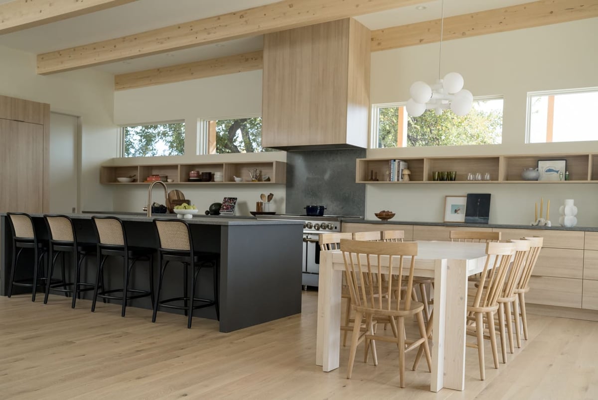 Wide view of kitchen and dining with island seating in Arvada, CO pop top renovation by Cillessen Construction