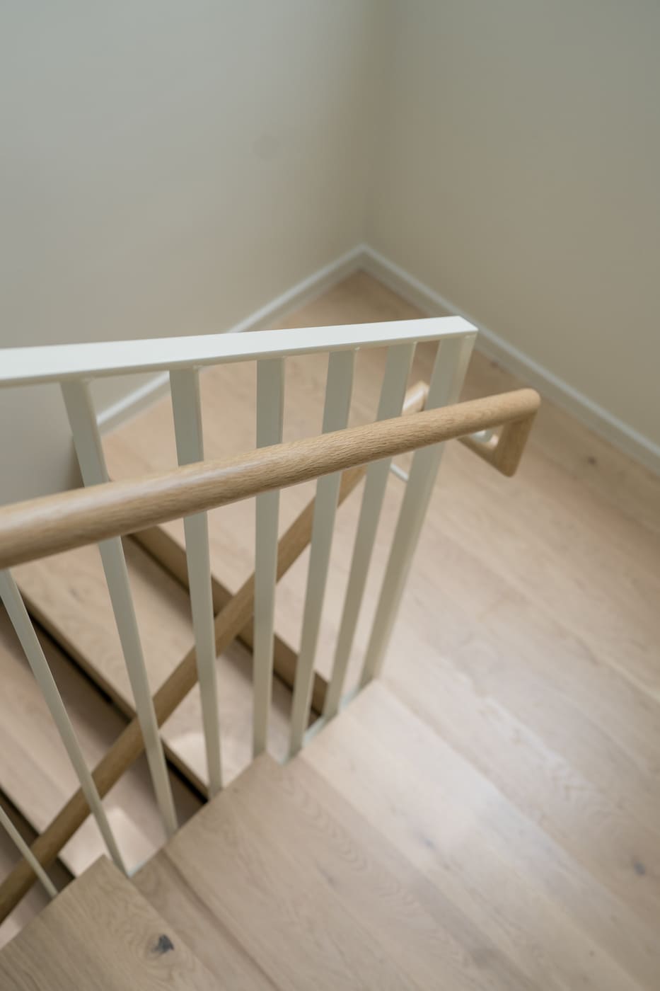Close-up of wood stair tread and railing detail in pop top renovation in Arvada, CO by Cillessen Construction