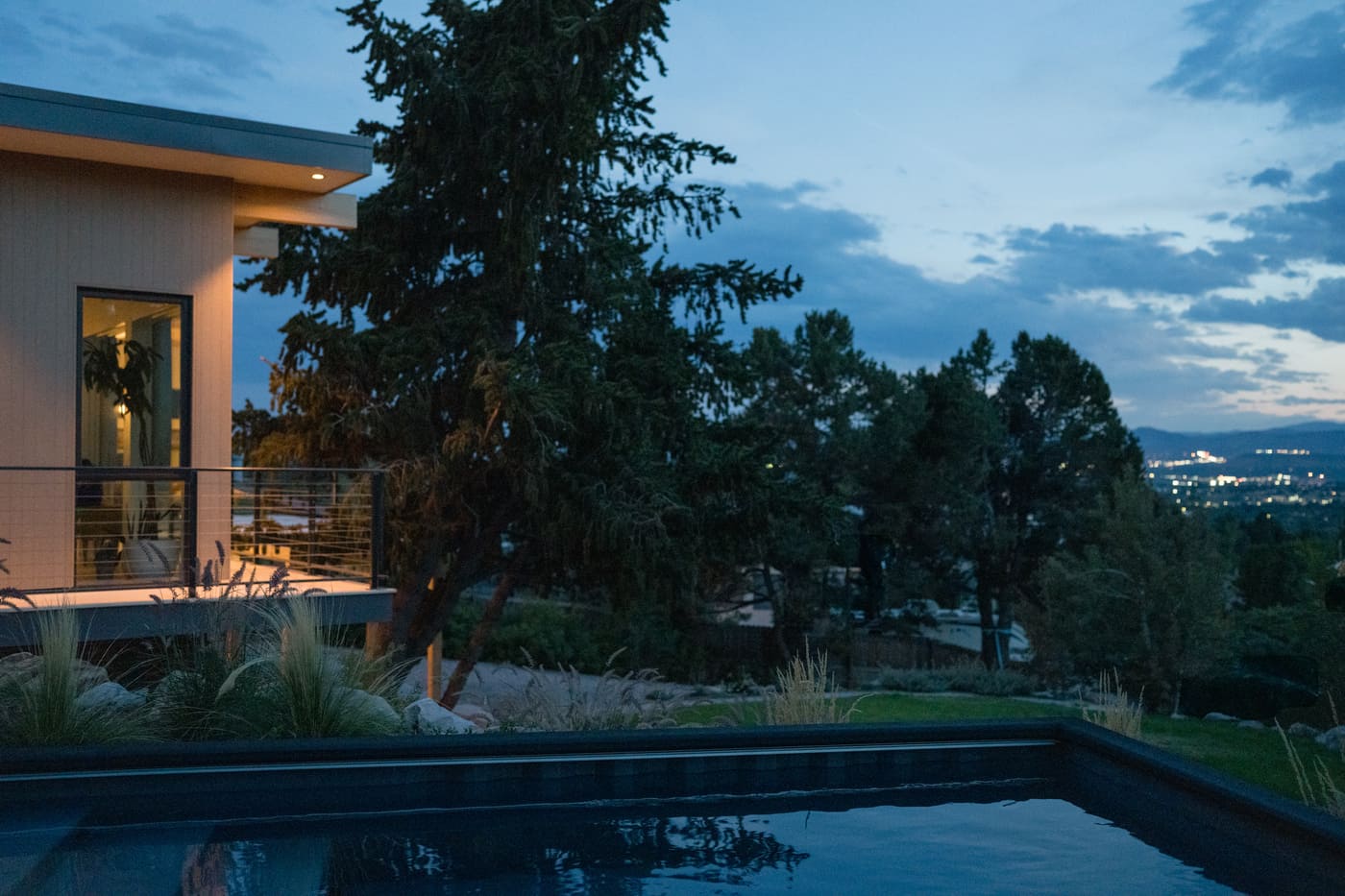Evening view of pop top renovation with deck overlooking landscaped yard in Arvada, CO by Cillessen Construction