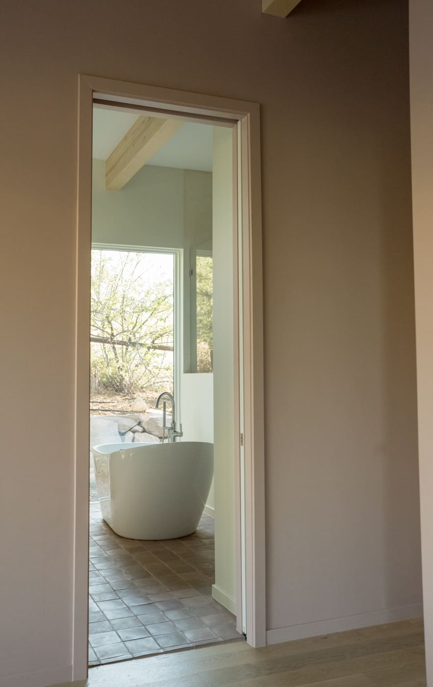 Freestanding tub viewed through doorway in Arvada, CO pop top renovation by Cillessen Construction
