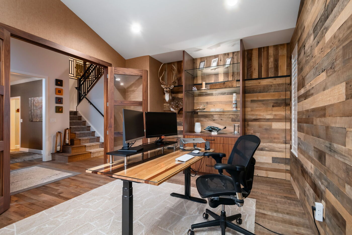 Littleton, CO whole home renovation home office with wood accent walls, built-ins, and dual monitors by Cillessen Construction