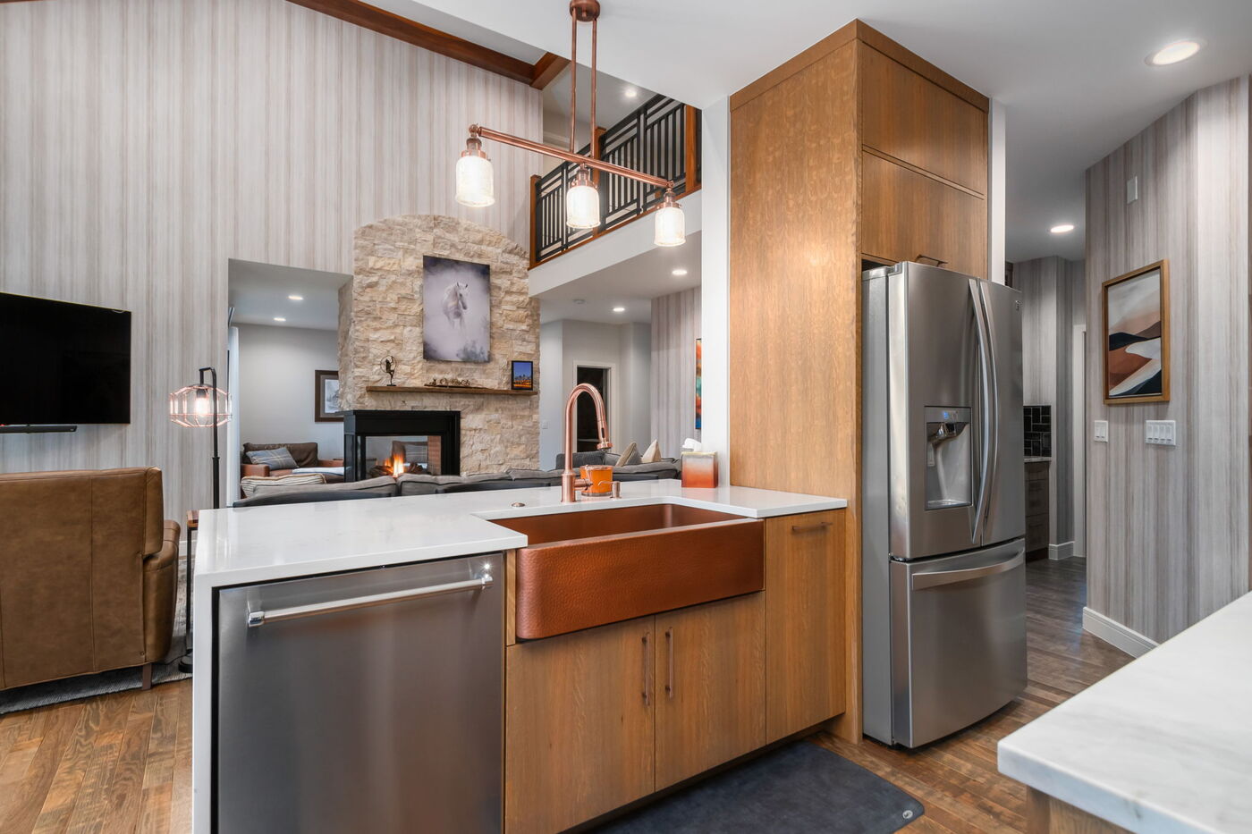 Littleton, CO whole home renovation kitchen with copper sink, island, and open living area by Cillessen Construction