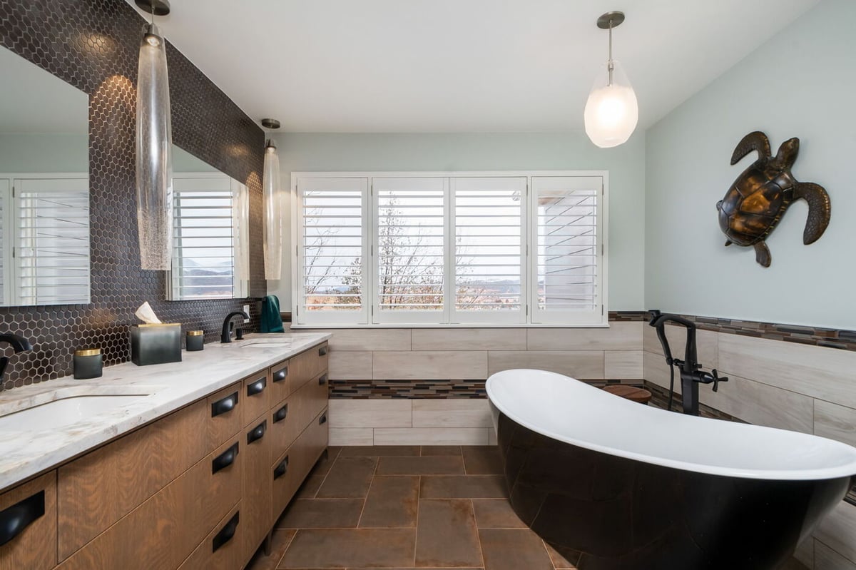 Littleton, CO whole home renovation bathroom with soaking tub, dual sinks, and large windows by Cillessen Construction