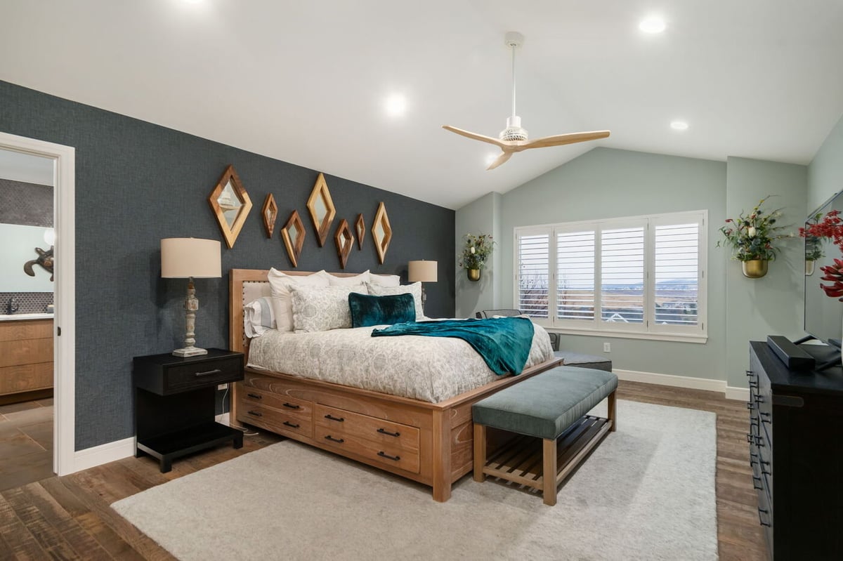 Littleton, CO whole home renovation bedroom with wood bed, accent wall, and large windows by Cillessen Construction