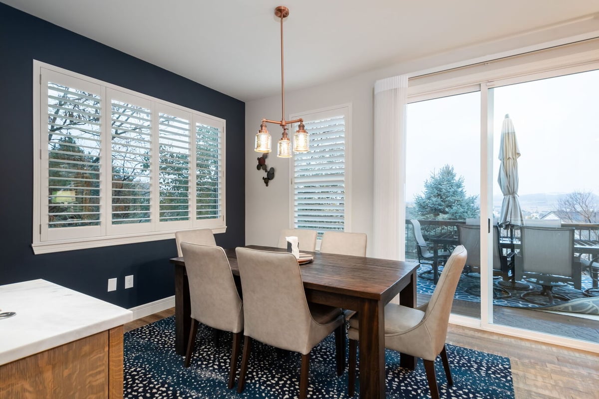 Littleton, CO whole home renovation dining area with modern lighting and patio access by Cillessen Construction