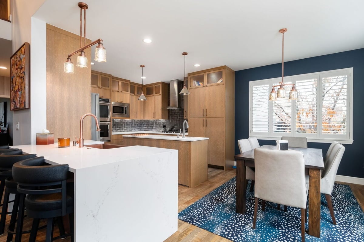 Littleton, CO whole home renovation kitchen and dining with island, pendant lighting, and open layout by Cillessen Construction